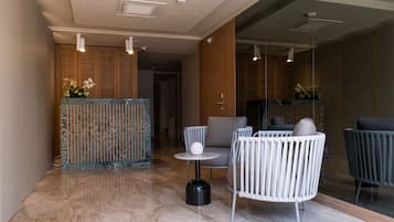 A modern interior with a seating area, a small table, and a decorative plant.