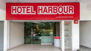 The entrance to Hotel Harbour with a red sign, glass doors, and a small number '18' sign on the wall. - Harbour Hotel (Petaling Jaya)