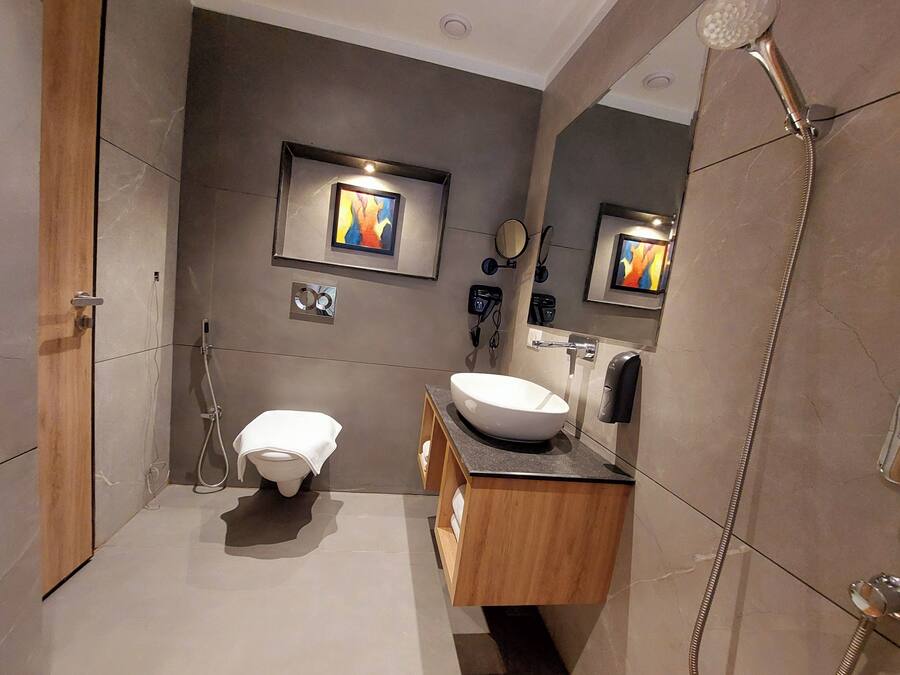 A modern bathroom with a toilet, sink, and shower.