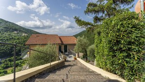A staircase leading to a building with a tiled roof, surrounded by greenery and hills. - Apartment in Recco with 1 bedrooms sleeps 4 (Recco)