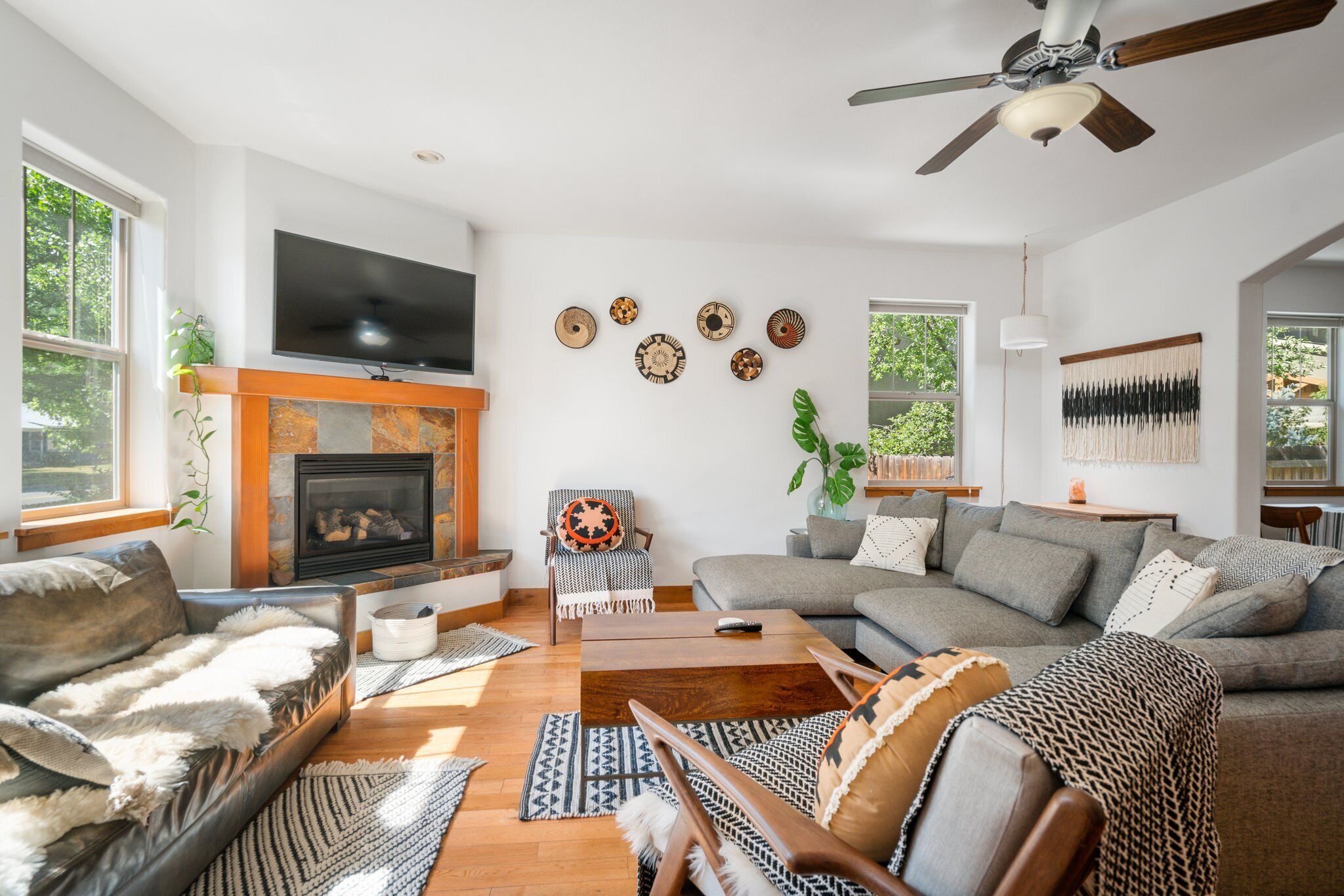 A living room with a fireplace, a sofa, a coffee table, and a television.