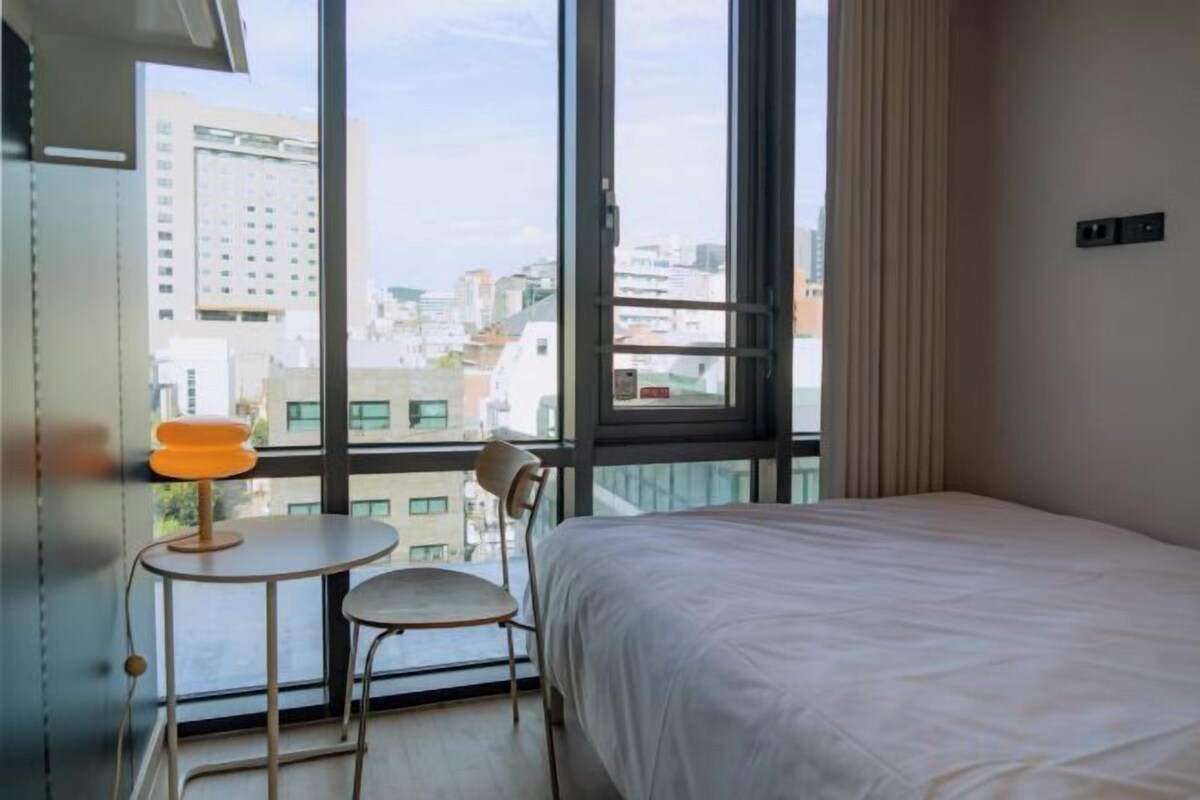 Premium bedding, desk, laptop workspace, soundproofing
