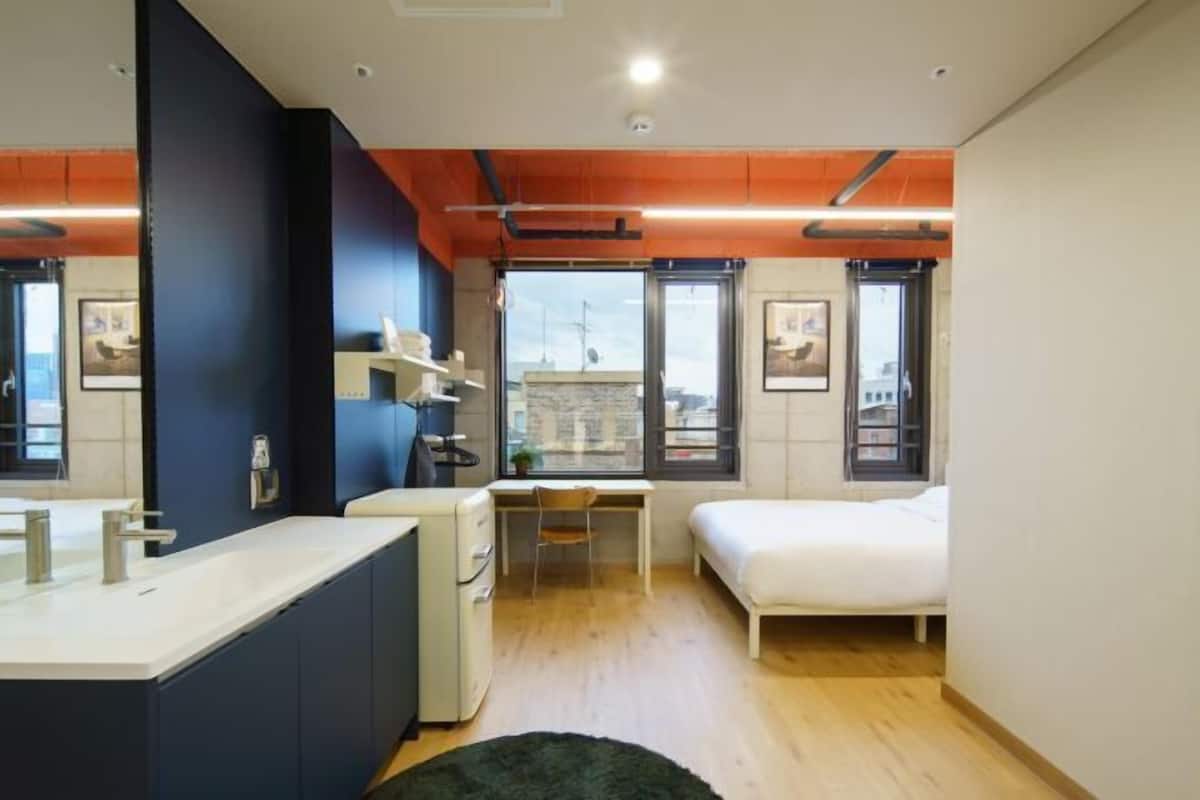 Premium bedding, desk, laptop workspace, soundproofing