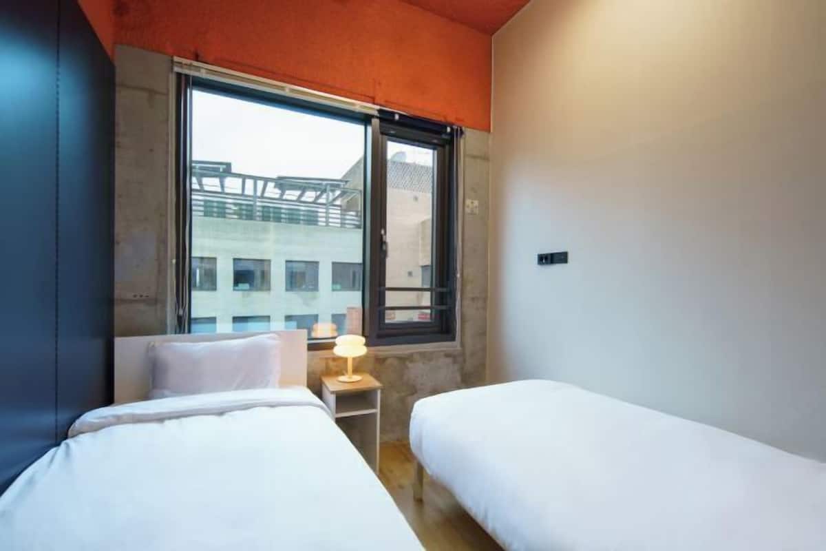 Premium bedding, desk, laptop workspace, soundproofing