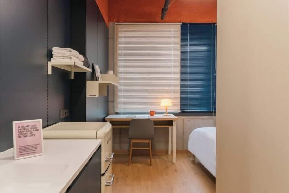 Premium bedding, desk, laptop workspace, soundproofing