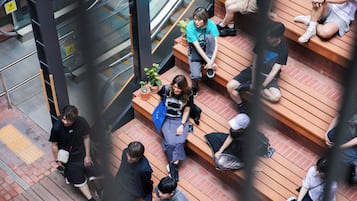 A multi-level public space with wooden steps and seating areas.