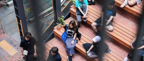 A multi-level public space with wooden steps and seating areas.