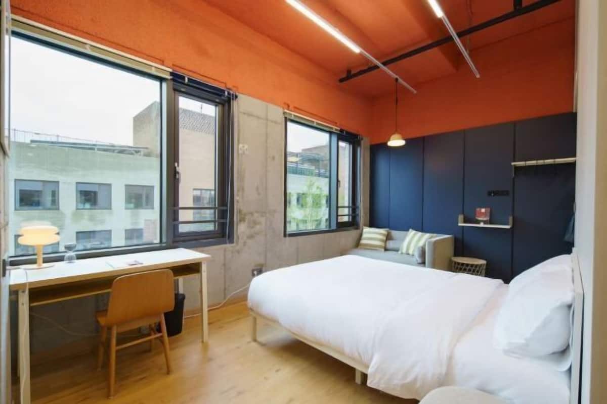 Premium bedding, desk, laptop workspace, soundproofing