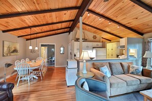 Relax in this inviting living area with a sofa, chairs, dining table, and kitchen.