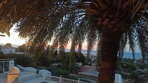 A pool area with a view of the sunset and surrounding buildings. - Beautiful Villa with gorgeous seaviews, close to the centre andbeaches of Denia. (Denia)
