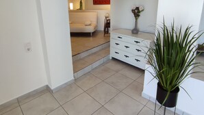 A modern living room with a white sofa, a coffee table, and a potted plant. - Beautiful Villa with gorgeous seaviews, close to the centre andbeaches of Denia. (Denia)