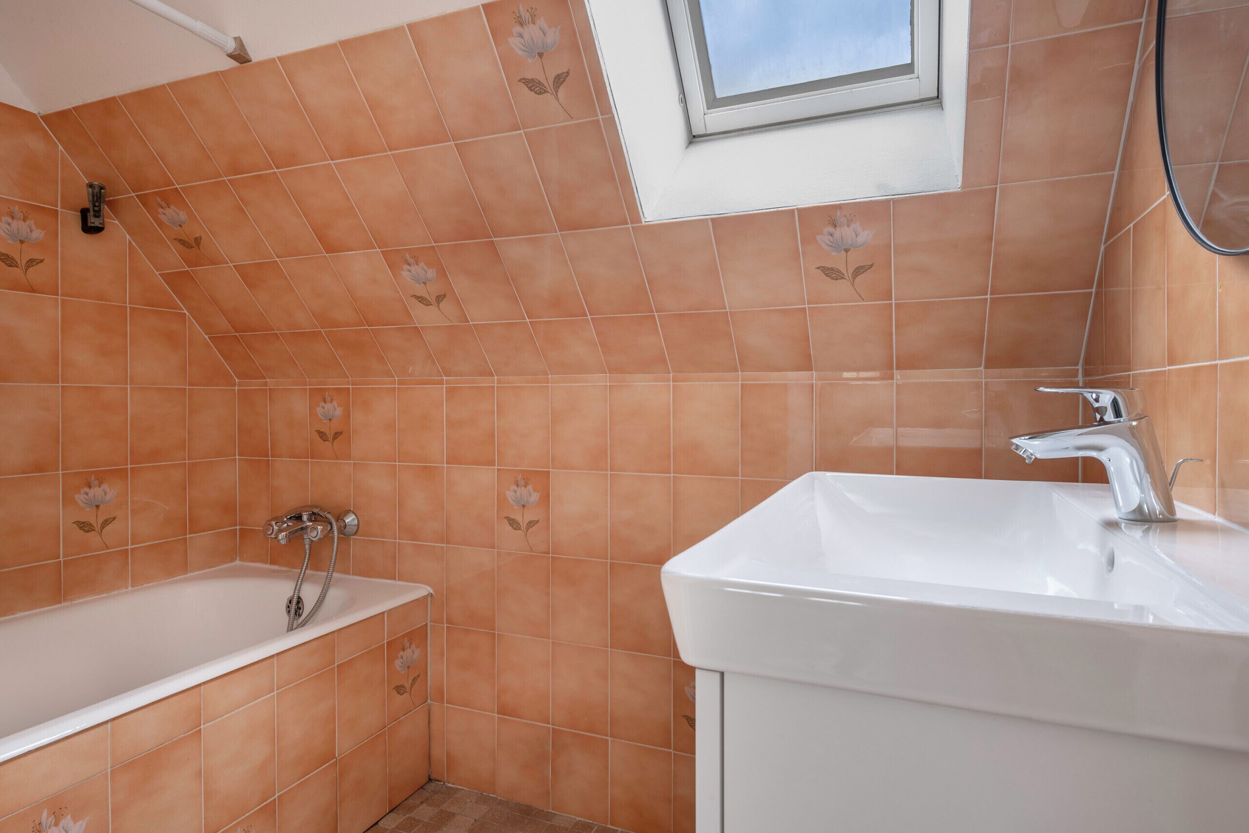 A bathroom with a bathtub, a sink, and a shower.