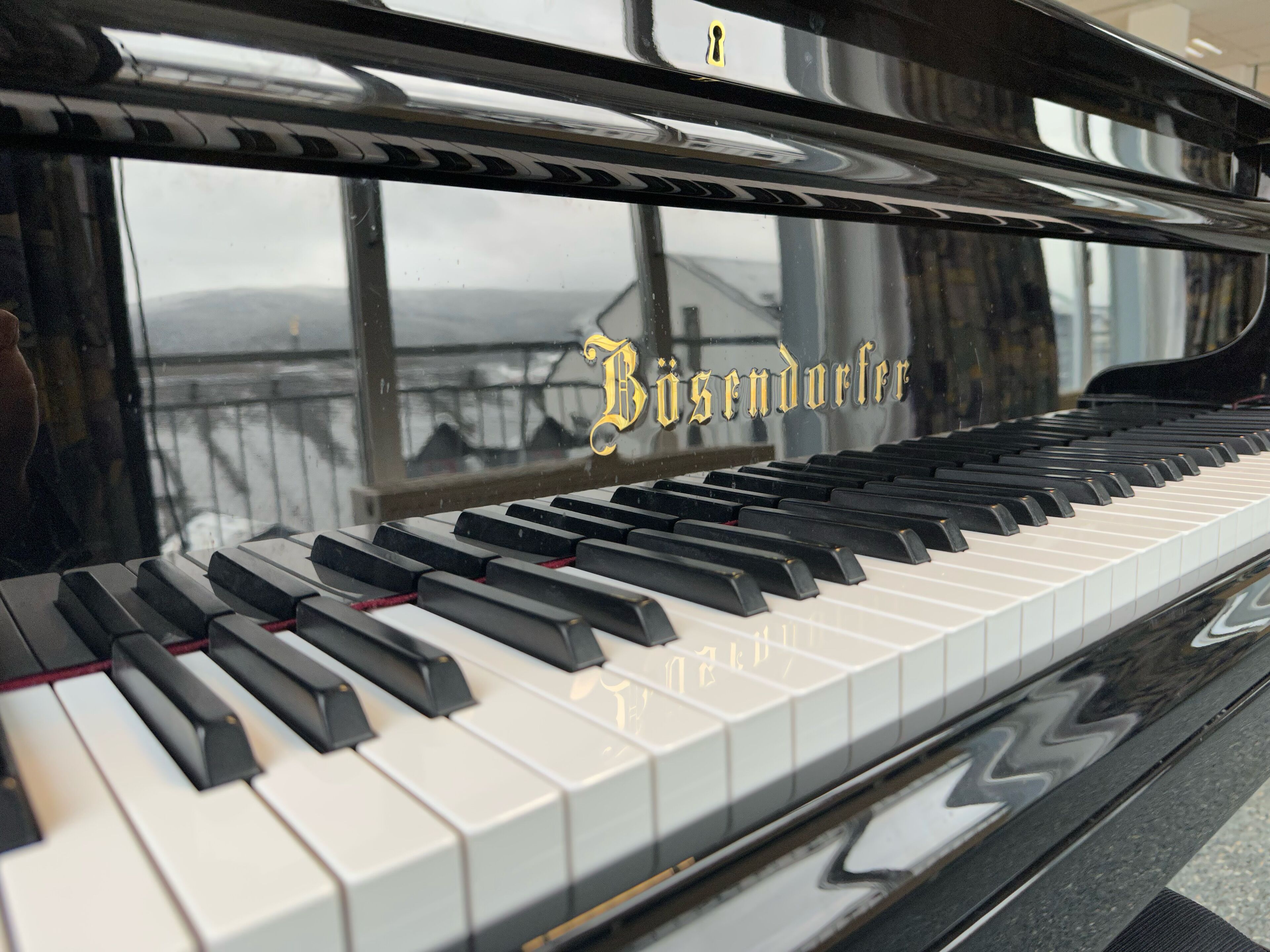 A piano with the inscription "Bösendorfer" on its side.