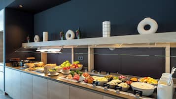 A buffet with various food items and a glass display case.