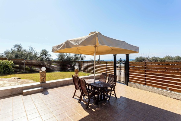 Exterior Patio of the House – Shaded outdoor space perfect for morning coffee or evening gatherings.