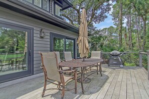 An outdoor patio with a table and chairs, a grill, and a pergola with a canopy. - New Listing in popular neighborhood (Kiawah Island)