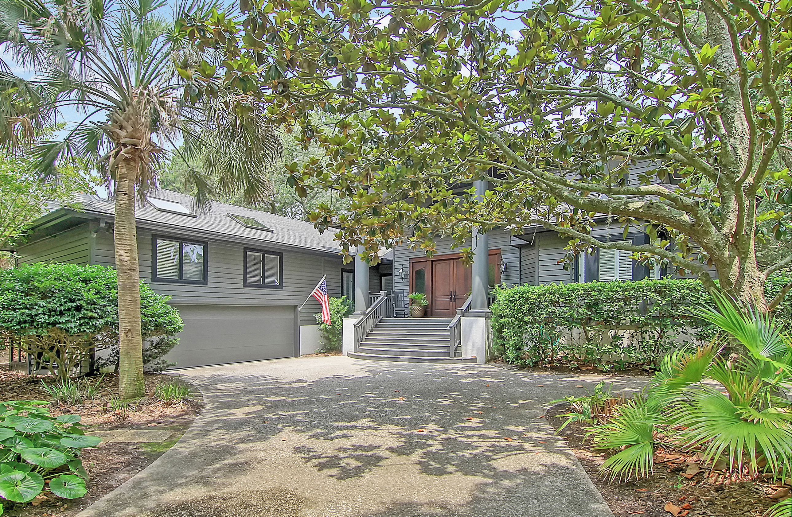 A residential house with a front porch, steps leading to the door, and a driveway.
