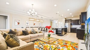 A modern living room with a sofa, coffee table, and artwork on the walls.