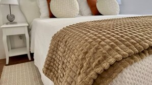 A neatly made bed with a brown knitted blanket, white pillows, and a white headboard. - Casa Santiago & Mafalda Lux Home in Olhao, Algarve (Olhao)
