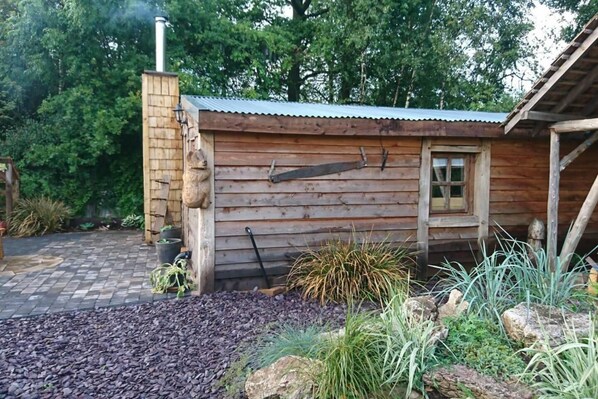 A rustic wooden cabin with a chimney, a window, and a door. - The Woodcutters Rest Cabin Sutton Coldfield (Sutton Coldfield)