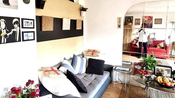 A modern living room with a sofa, coffee table, and decorative items. - Lovely 2-bed Apartment in Battersea, London (London)