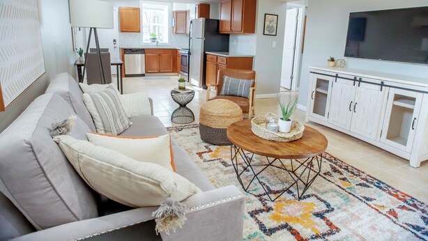 A modern living room with a sofa, coffee table, and a TV. - Cozy Basement Suite with Full Kitchen, Walk to Edgewood (Atlanta)