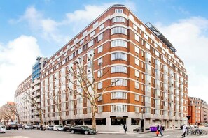 Experience the unique blend of traditional architecture and modern design at this urban hotel, featuring a distinctive facade with balconies and a curved corner.