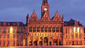 A historic building with a prominent clock tower, arched windows, and a symmetrical facade. - A 5mn du Centre Ville (Saint-Quentin)