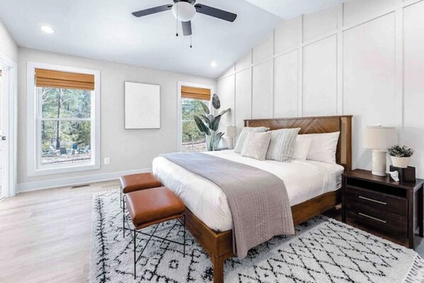 A bedroom with a bed, a bench, a nightstand, a ceiling fan, and large windows. - Waterfront, Firepit, Kayak, Game room, Potomac 2hrs from DC, Dogs+EV OK (Montross)