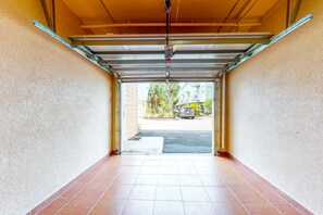 Enter a garage with a tiled floor and metal beam structure.