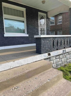 Stylish brick exterior with a stone accent wall and a decorative element above the entrance.