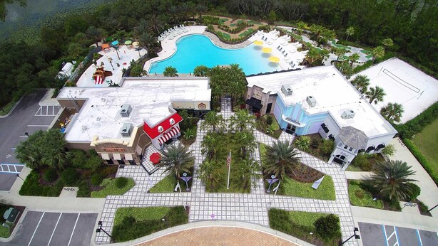 A resort with a swimming pool, a golf course, and a parking lot. - Festival Resort 5 Bd Home w Screened Pool Close to Disney 174 (Davenport)