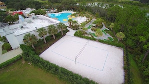 An aerial view of a resort with a swimming pool, tennis court, and lush greenery. - Festival Resort 5 Bd Home w Screened Pool Close to Disney 174 (Davenport)