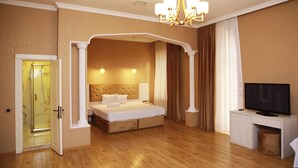 A hotel room with a large bed, a television, and a desk. - Deluxe Hotel Ganja (Ganja)