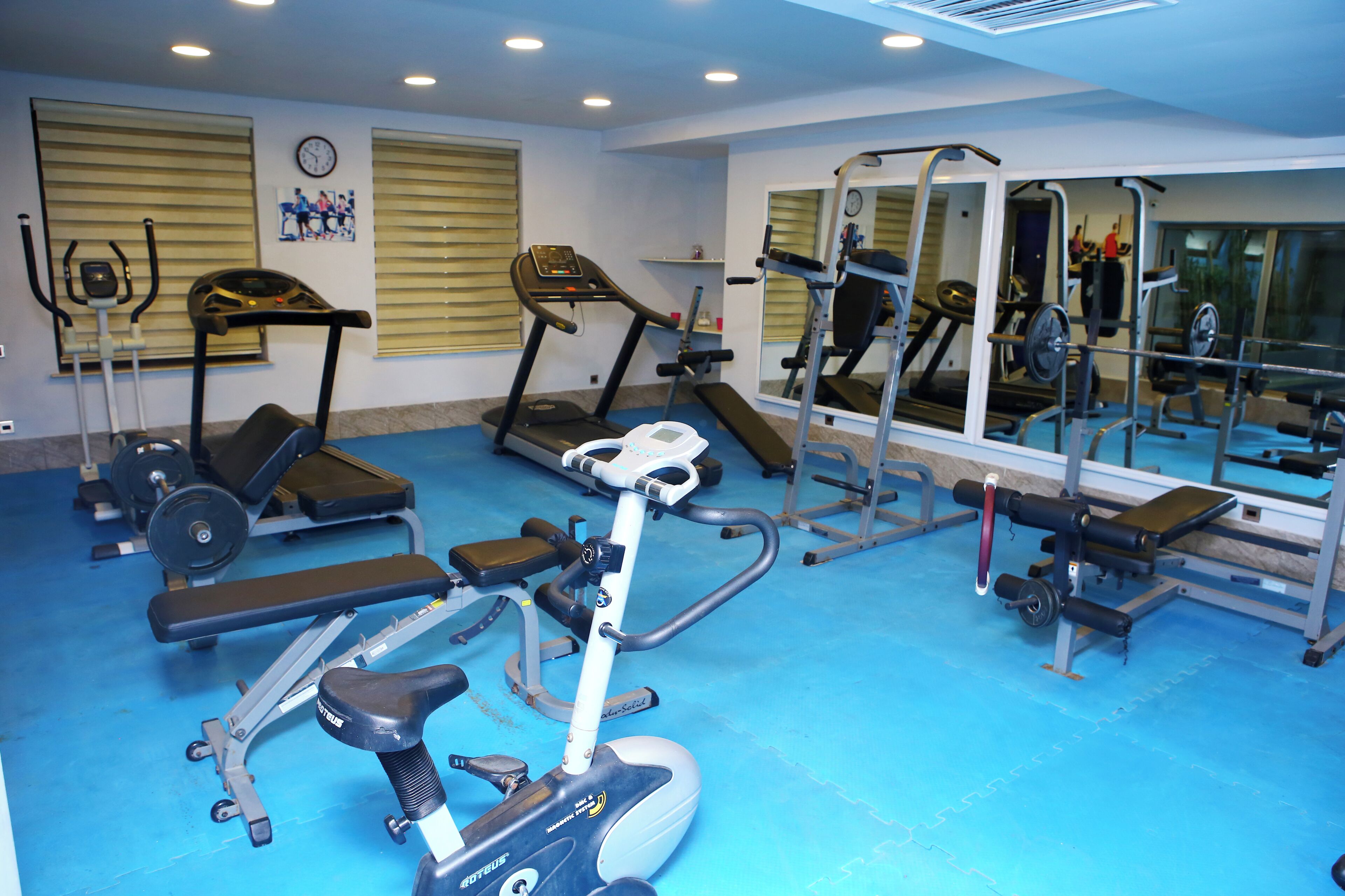 A gym with treadmills, ellipticals, and weight machines.