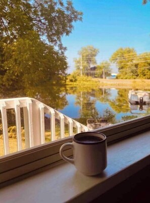 Enjoy serene views of the water and surrounding landscape from the balcony.