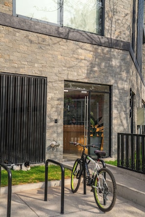 Guests can enjoy a convenient entrance with ample natural light and a secure parking area for bicycles.