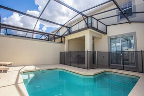 A swimming pool with a glass ceiling, a covered patio, and a view of the sky. - Four Bedroom Storey Lake Resort Close to Disney w Pool 3063 (Kissimmee)