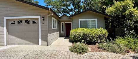A single-story house with a garage, a front door, and a small porch area.