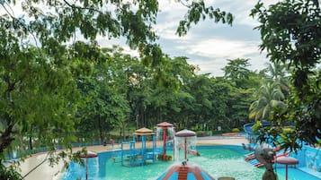 Parque acuático con piscina central, toboganes y zona de juegos de agua.