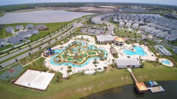 An aerial view of a resort with a large water park, multiple swimming pools, and a variety of recreational facilities.