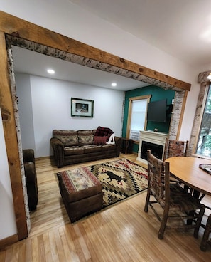 The living room, TV and fireplace - Birch Suite at Colden Lodge is a Romantic Waterfront Adirondack Private Suite. (Saranac Lake)