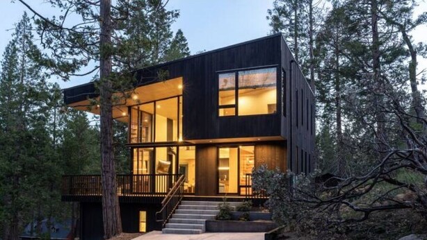 A modern two-story house with large windows, a balcony, and a staircase leading to the entrance. - Modern Sophistication Bathed in Natural Light (Wawona)