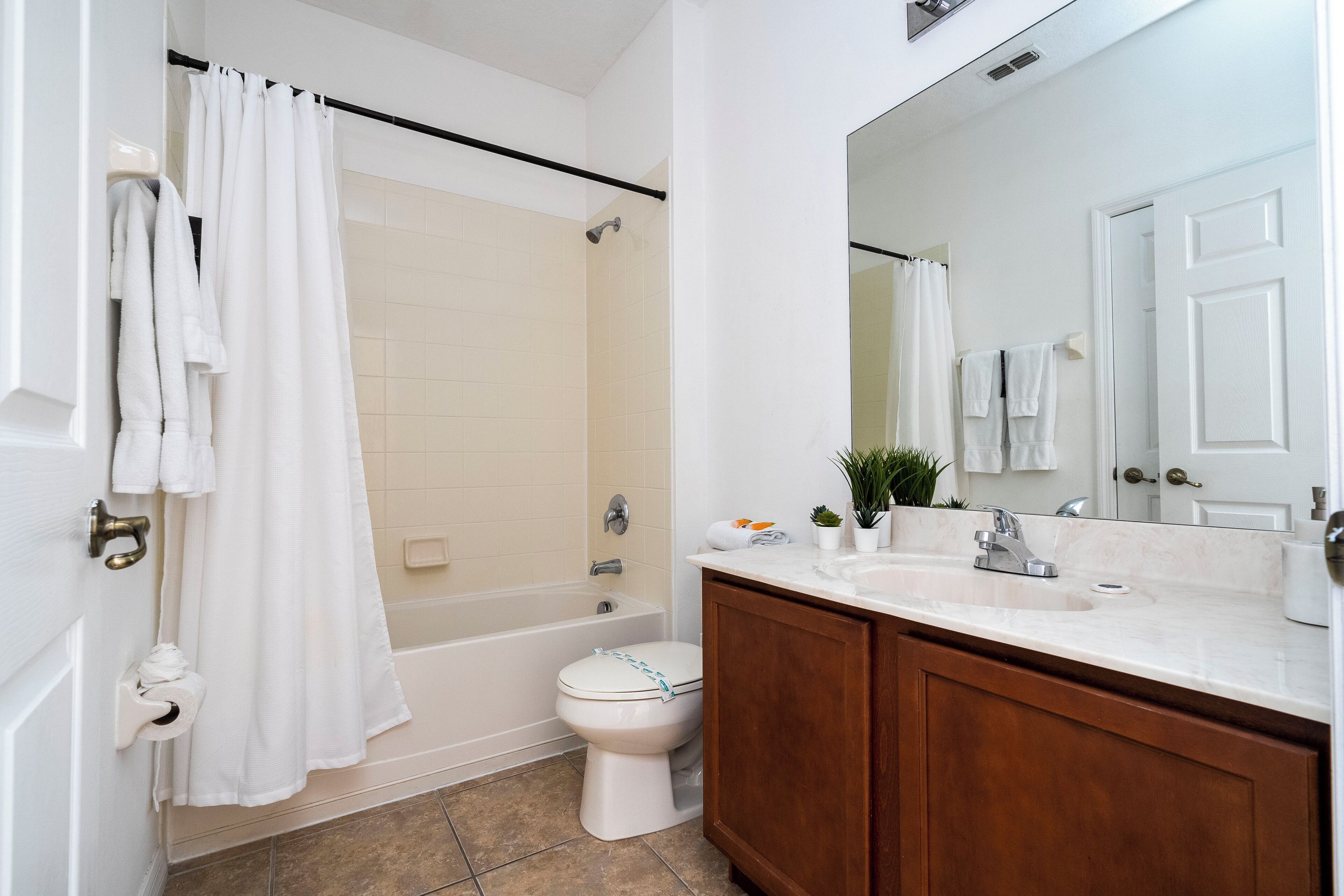A bathroom with a bathtub, toilet, and sink.