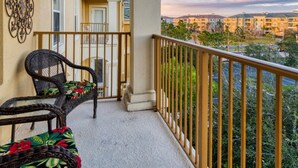 A balcony with a view of other buildings and a cloudy sky. - Deluxe 3 Bedroom Apartment Vista Cay Resort 404 (Orlando)