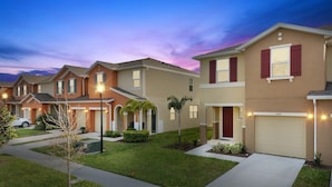 A row of modern townhouses with a well-maintained lawn and a clear sky. - Four Bedroom Gameroom Compass Bay Resort 5128a (Kissimmee)