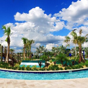 A swimming pool surrounded by palm trees and a jungle gym. - Stunning 5 Bd Home w Pool Close to Disney 4822 (Kissimmee)