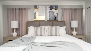 Un dormitorio ordenado con una cama grande, dos mesitas de noche y una obra de arte abstracta sobre la cama.