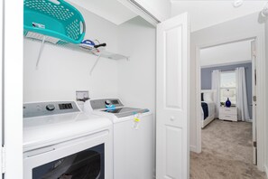A laundry room with two washing machines and a drying rack. - Stunning 4 Bd w Pool Close to Disney Champions Gate 990 (Davenport)