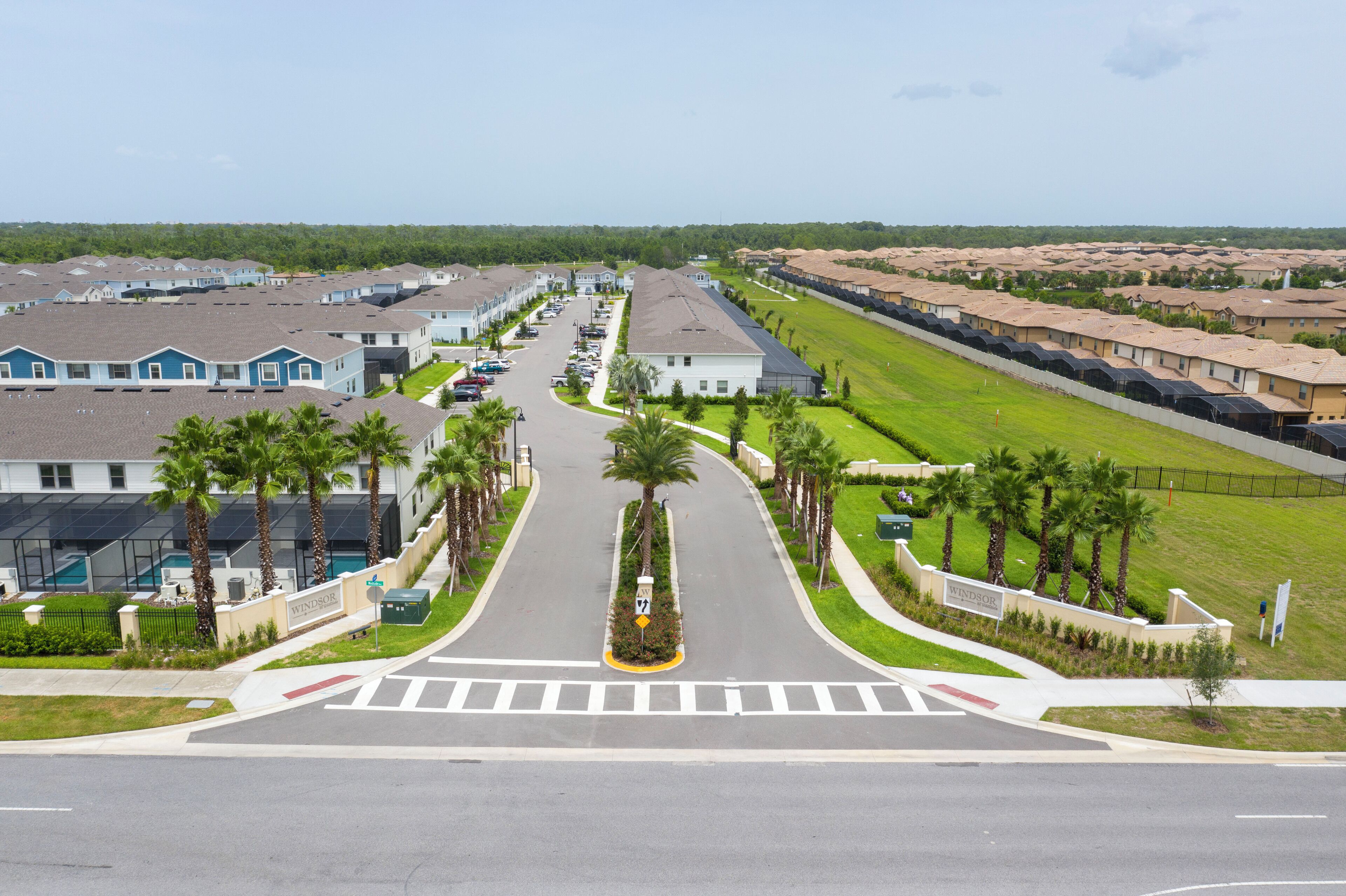 A residential area with a main road, houses, and a golf course.